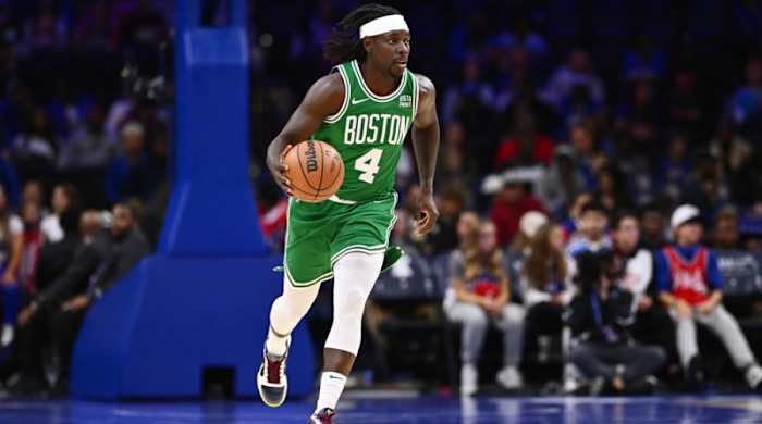 Boston Celtics guard Jrue Holiday brings up the ball.